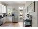 Bright kitchen with stainless steel refrigerator, white cabinets, and hardwood floors extending to the rear entryway at 2445 N Franklin St, Denver, CO 80205