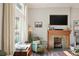 Comfortable living room with a fireplace, bright window, and inviting decor at 2445 N Franklin St, Denver, CO 80205