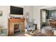 Cozy living room with a fireplace, mantel, hardwood floors, and natural light at 2445 N Franklin St, Denver, CO 80205