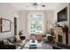 Bright living room featuring a fireplace, large windows, and hardwood floors at 2445 N Franklin St, Denver, CO 80205