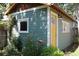 Well-maintained shed with a bright yellow door, adding character to the backyard at 2445 N Franklin St, Denver, CO 80205