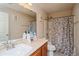 Bathroom featuring neutral colors, a shower with a curtain, and vanity mirror at 9675 E 105Th Ave, Commerce City, CO 80640