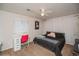 Bedroom with carpeting, a ceiling fan, natural light, a desk, and simple decor and neutral walls at 9675 E 105Th Ave, Commerce City, CO 80640