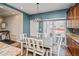 Cozy dining area featuring a sliding glass door and modern lighting fixture at 9675 E 105Th Ave, Commerce City, CO 80640