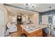 Open-concept kitchen and living area with large island, granite countertops, and modern appliances at 9675 E 105Th Ave, Commerce City, CO 80640