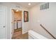 Bright laundry room with modern washer and dryer visible from the landing at the top of the stairs at 9675 E 105Th Ave, Commerce City, CO 80640
