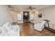 Comfortable living room with a ceiling fan, natural light, and hardwood floors at 9675 E 105Th Ave, Commerce City, CO 80640
