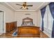Ornate, carved wood bed frame with luxurious bedding, hardwood floors and coffered ceilings at 9675 E 105Th Ave, Commerce City, CO 80640