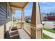 Inviting covered front porch with seating area, perfect for enjoying the neighborhood views at 9675 E 105Th Ave, Commerce City, CO 80640