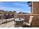 Cozy balcony with outdoor seating overlooking the street and neighboring townhomes at 9225 Rockhurst St # A, Highlands Ranch, CO 80129