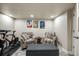 Relaxing basement area with comfortable armchairs, a center table, and cycling-themed art at 9225 Rockhurst St # A, Highlands Ranch, CO 80129