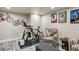 Basement space with exercise equipment, comfortable seating, and bike decor at 9225 Rockhurst St # A, Highlands Ranch, CO 80129
