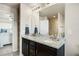 Bathroom featuring a double sink vanity, granite countertops, and shower at 9225 Rockhurst St # A, Highlands Ranch, CO 80129