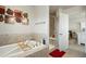 Bathroom featuring tub, tiled shower, and access to an adjacent room at 9225 Rockhurst St # A, Highlands Ranch, CO 80129