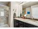 Bathroom featuring a double sink vanity, granite countertops, and shower at 9225 Rockhurst St # A, Highlands Ranch, CO 80129