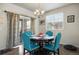 Cozy dining room with wood table, upholstered chairs, chandelier, and natural light at 9225 Rockhurst St # A, Highlands Ranch, CO 80129
