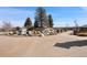 Community entrance with signature signage amidst beautiful greenery at 9225 Rockhurst St # A, Highlands Ranch, CO 80129