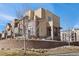 Stunning brick townhome with multiple stories, patios, and landscaped surroundings on a sunny day at 9225 Rockhurst St # A, Highlands Ranch, CO 80129