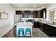 Modern kitchen with stainless steel appliances, dark cabinets, and granite countertops at 9225 Rockhurst St # A, Highlands Ranch, CO 80129