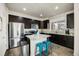 Modern kitchen features stainless steel appliances, dark cabinets, granite countertops, and a center island at 9225 Rockhurst St # A, Highlands Ranch, CO 80129