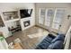 Sun-drenched living room featuring a fireplace, hardwood floors, and large windows with blinds at 9225 Rockhurst St # A, Highlands Ranch, CO 80129