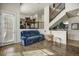 Cozy living room with hardwood floors, modern staircase and blue couch with ample seating at 9225 Rockhurst St # A, Highlands Ranch, CO 80129