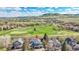 Beautiful home with golf course views, lush greenery, and mountain views in the background at 17280 W 70Th Ave, Arvada, CO 80007