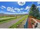 Picturesque backyard offering a scenic view, gravel road, and fencing, creating a tranquil outdoor retreat at 17280 W 70Th Ave, Arvada, CO 80007