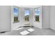 Bright balcony with stunning outdoor views of green grass and mountain backdrops. The room has large windows at 17280 W 70Th Ave, Arvada, CO 80007