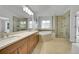This primary bathroom features double vanities, soaking tub, glass shower, and modern fixtures at 17280 W 70Th Ave, Arvada, CO 80007