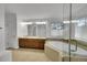 This primary bathroom features double vanities, soaking tub, glass shower, and modern fixtures at 17280 W 70Th Ave, Arvada, CO 80007
