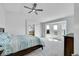 Bright primary bedroom with vaulted ceilings, ceiling fan, and walkout balcony with stunning mountain views at 17280 W 70Th Ave, Arvada, CO 80007