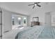 Bright primary bedroom with vaulted ceilings, ceiling fan, and walkout balcony with stunning mountain views at 17280 W 70Th Ave, Arvada, CO 80007