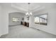 Bright dining room area with gray carpet, modern light fixture and built-in desk spaces at 17280 W 70Th Ave, Arvada, CO 80007