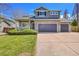 Charming two-story home with a stone facade and a well-manicured lawn at 17280 W 70Th Ave, Arvada, CO 80007