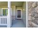 Inviting front porch with stone accents and a stylish, dark-colored front door at 17280 W 70Th Ave, Arvada, CO 80007
