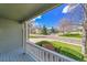 Inviting front porch with white railing and a view of the well-kept neighborhood at 17280 W 70Th Ave, Arvada, CO 80007