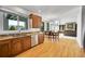 An open-concept kitchen featuring wood floors, granite counters, and a view into the living area at 17280 W 70Th Ave, Arvada, CO 80007