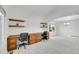 Bright and airy office space featuring built-in desks, shelving, and natural light at 17280 W 70Th Ave, Arvada, CO 80007