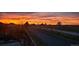 Scenic landscape with a colorful sunset sky, silhouetted trees, and distant hills at 17280 W 70Th Ave, Arvada, CO 80007