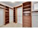 Spacious walk-in closet with custom wood shelving and ample storage, perfect for organizing your wardrobe at 17280 W 70Th Ave, Arvada, CO 80007