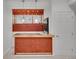 Wet bar featuring wooden cabinets, a sink, mini-fridge, and lighting, perfect for entertaining at 17280 W 70Th Ave, Arvada, CO 80007