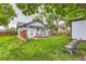 Charming backyard featuring a deck and lush garden, perfect for outdoor living at 3396 S Logan St, Englewood, CO 80113