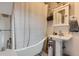 Elegant bathroom featuring a clawfoot tub, pedestal sink, and decorative accents at 3396 S Logan St, Englewood, CO 80113