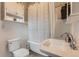Classic bathroom with vintage-style fixtures, pedestal sink, and traditional wainscoting at 3396 S Logan St, Englewood, CO 80113