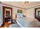 Cozy bedroom with neutral tones, decorative trim, and multiple doorways at 3396 S Logan St, Englewood, CO 80113