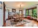Dining room featuring hardwood floors, a large wooden dining table, and a decorative rug, perfect for Gathering gatherings at 3396 S Logan St, Englewood, CO 80113