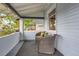 Cozy front porch with two wicker chairs, providing a relaxing outdoor seating area with a view of the neighborhood at 3396 S Logan St, Englewood, CO 80113