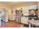Kitchen with stainless steel appliances, white cabinets, granite countertops and laminate flooring at 3396 S Logan St, Englewood, CO 80113