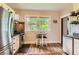 Well-lit kitchen features stainless appliances, stylish flooring, and a cozy breakfast nook at 3396 S Logan St, Englewood, CO 80113